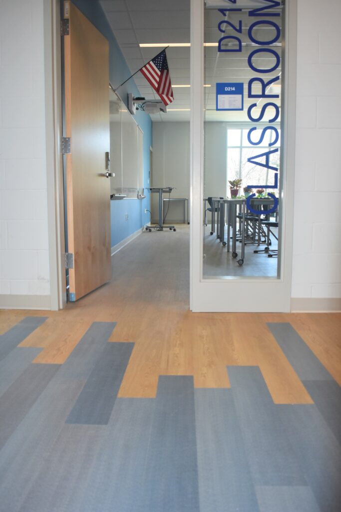 Capozza Commercial Division - 24371 - Ledgewood Construction - Lewiston High School - Classroom and Hall - blue and oak - LVT - Vinyl - Mannington - Spacia - woodlook