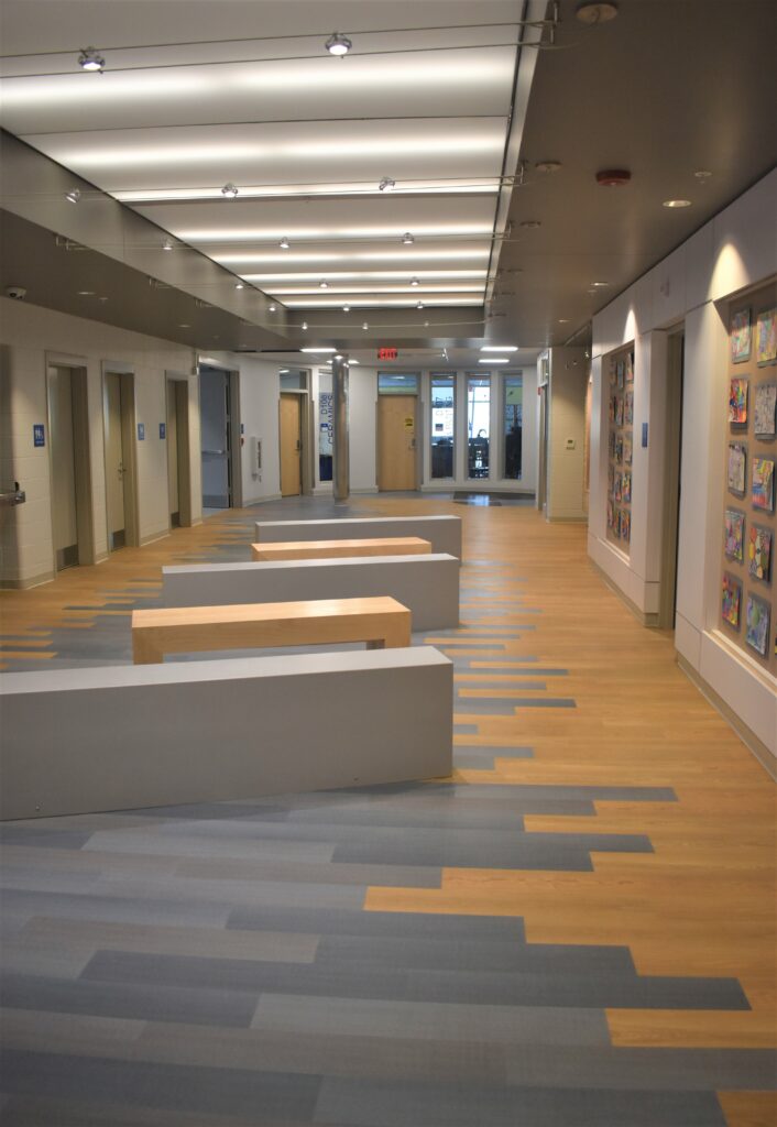 Capozza Commercial Division - 24371 - Ledgewood Construction - Lewiston High School Hall - LVT - Vinyl - Mannington - Spacia First - Wood - Pale Ash - Brunnea - Linear