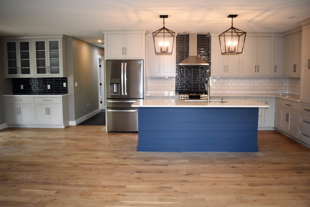 Capozza Tile - Residential - Clover Way - Larry Donatello - Open Concept Kitchen - Backsplash - White Subway - Blue - Harwood Floors